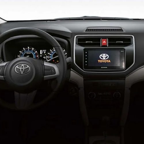 Close-up of the dashboard in the 2023 Toyota Rush, displaying the infotainment system, controls, and instrument panel.