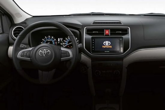 Close-up of the dashboard in the 2023 Toyota Rush, displaying the infotainment system, controls, and instrument panel.